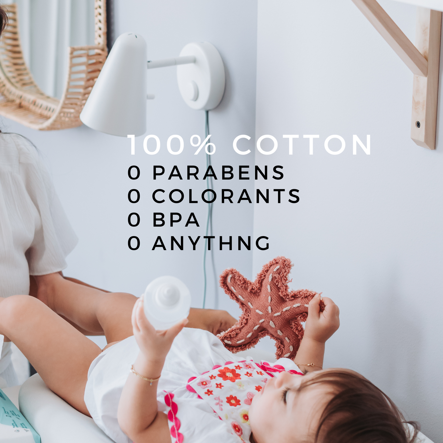 A baby lying on a changing table holding a toy starfish, with text highlighting **Koko Wipes – 100% Cotton**, emphasizing zero parabens, colorants, BPA, or chemicals.