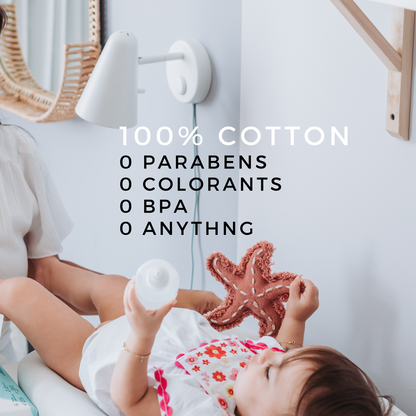 A baby lying on a changing table holding a toy starfish, with text highlighting **Koko Wipes – 100% Cotton**, emphasizing zero parabens, colorants, BPA, or chemicals.